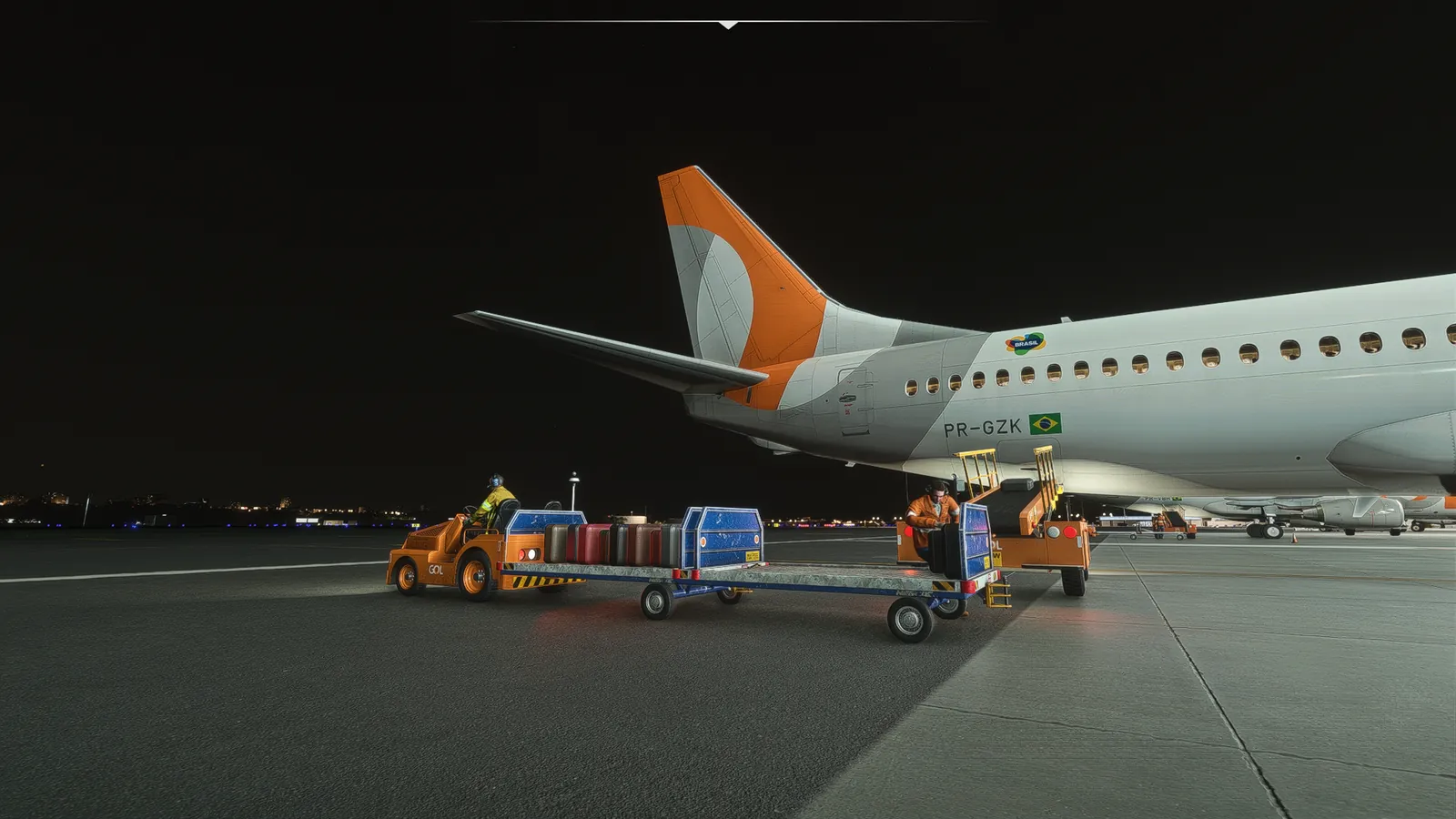 Baggage tug with carts full of suitcases next to a belt loader at the rear hold of a 737.